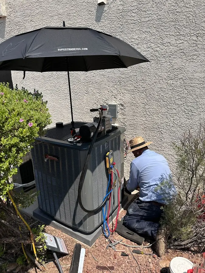 HVAC technician performing outdoor AC maintenance in Eidson Road